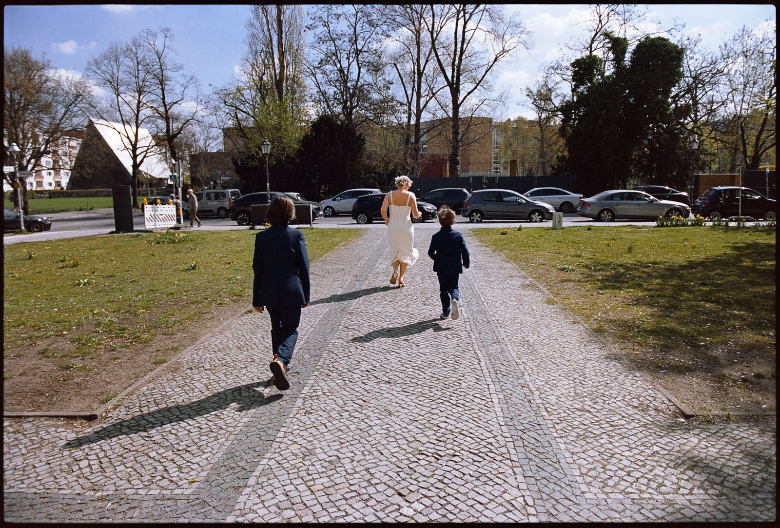 Children running ahead as the couple walk a path