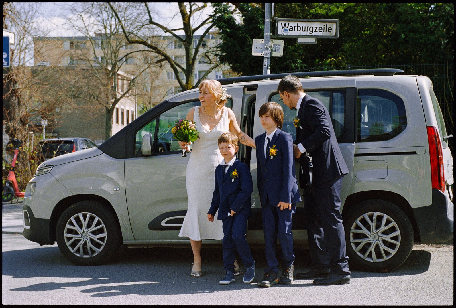 The couple and family by the car