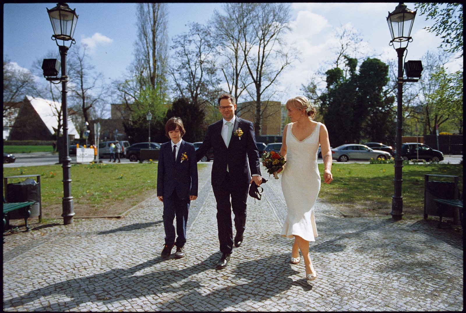 The couple and a child walking across a square