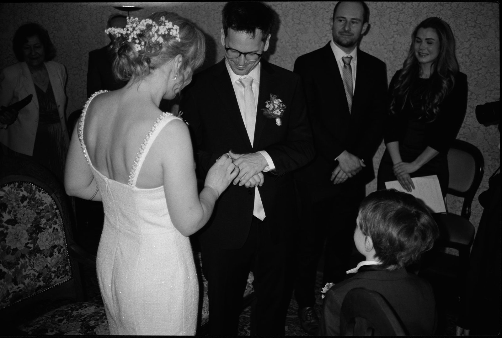 The couple exchanging rings, in black and white