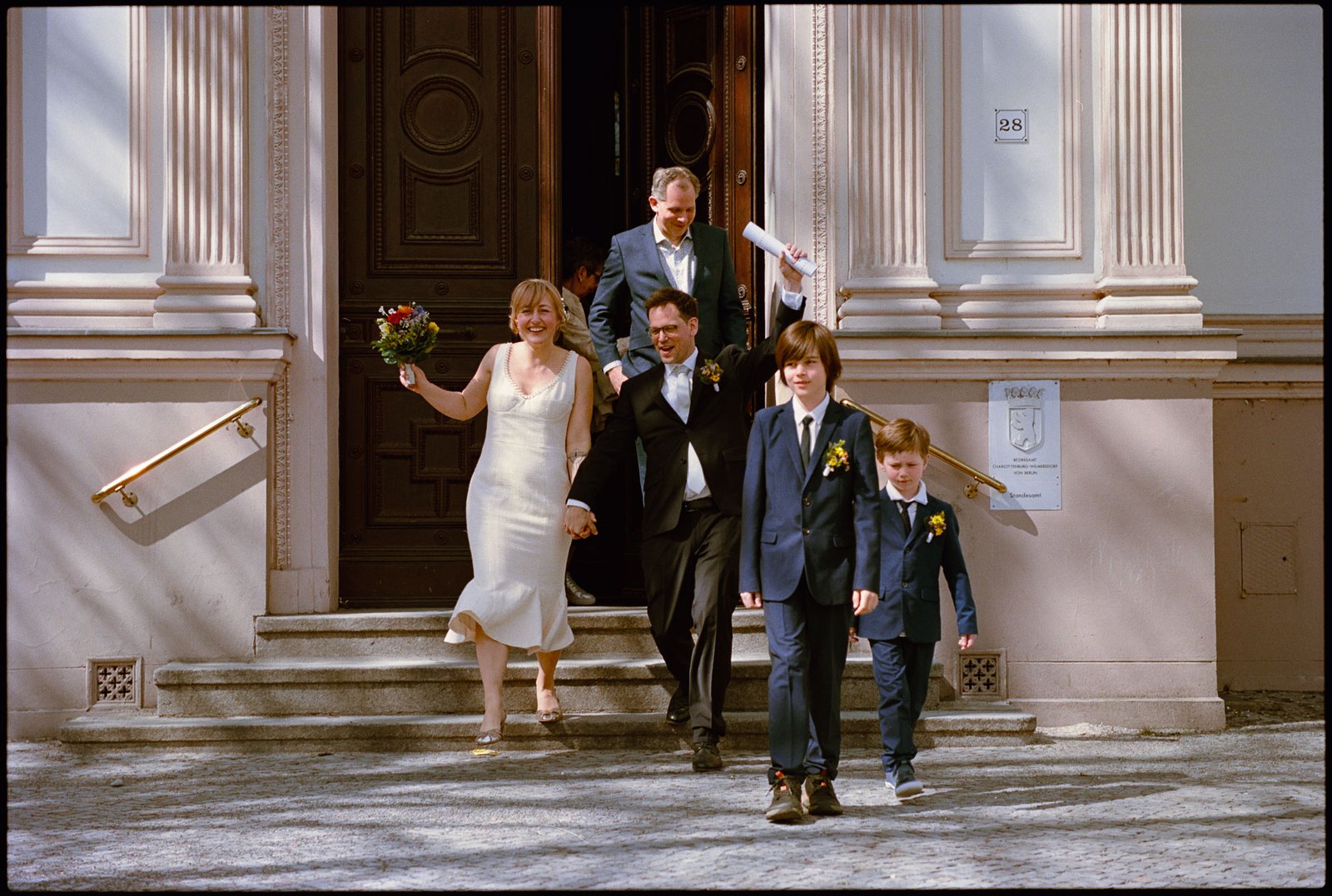 The couple leaving the registry office down the steps