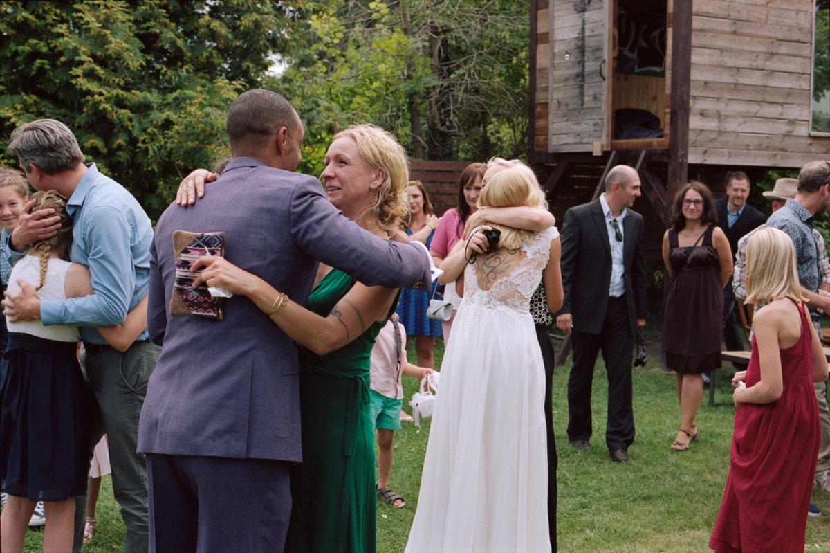 The groom embracing guests after the ceremony