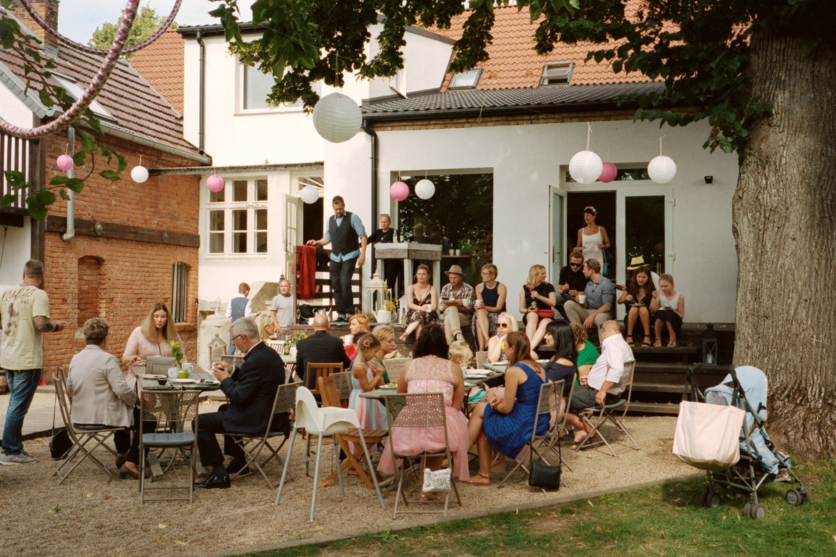 Guests at the outdoor reception outside the brick house
