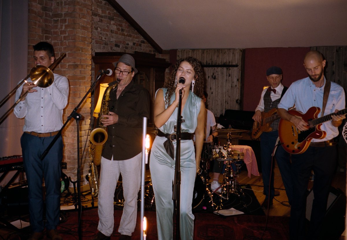 A band playing brass and vocals at the reception