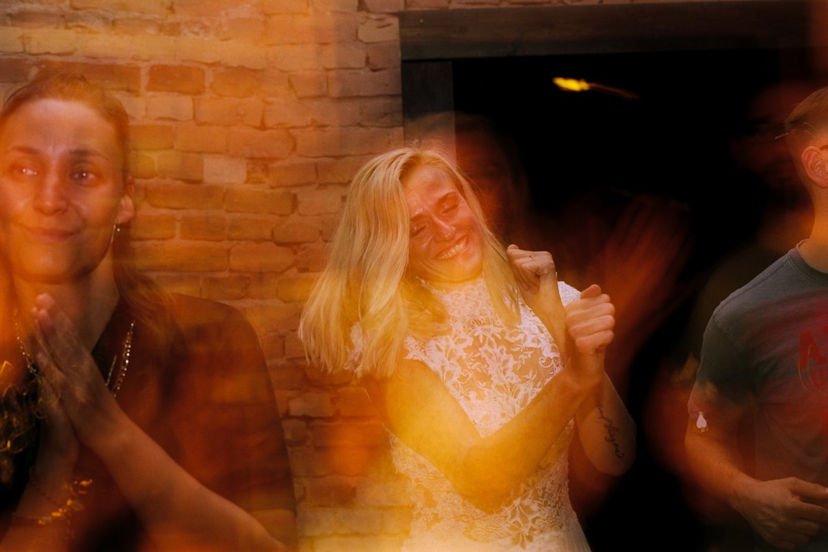 The couple dancing in warm light, a long-exposure film frame