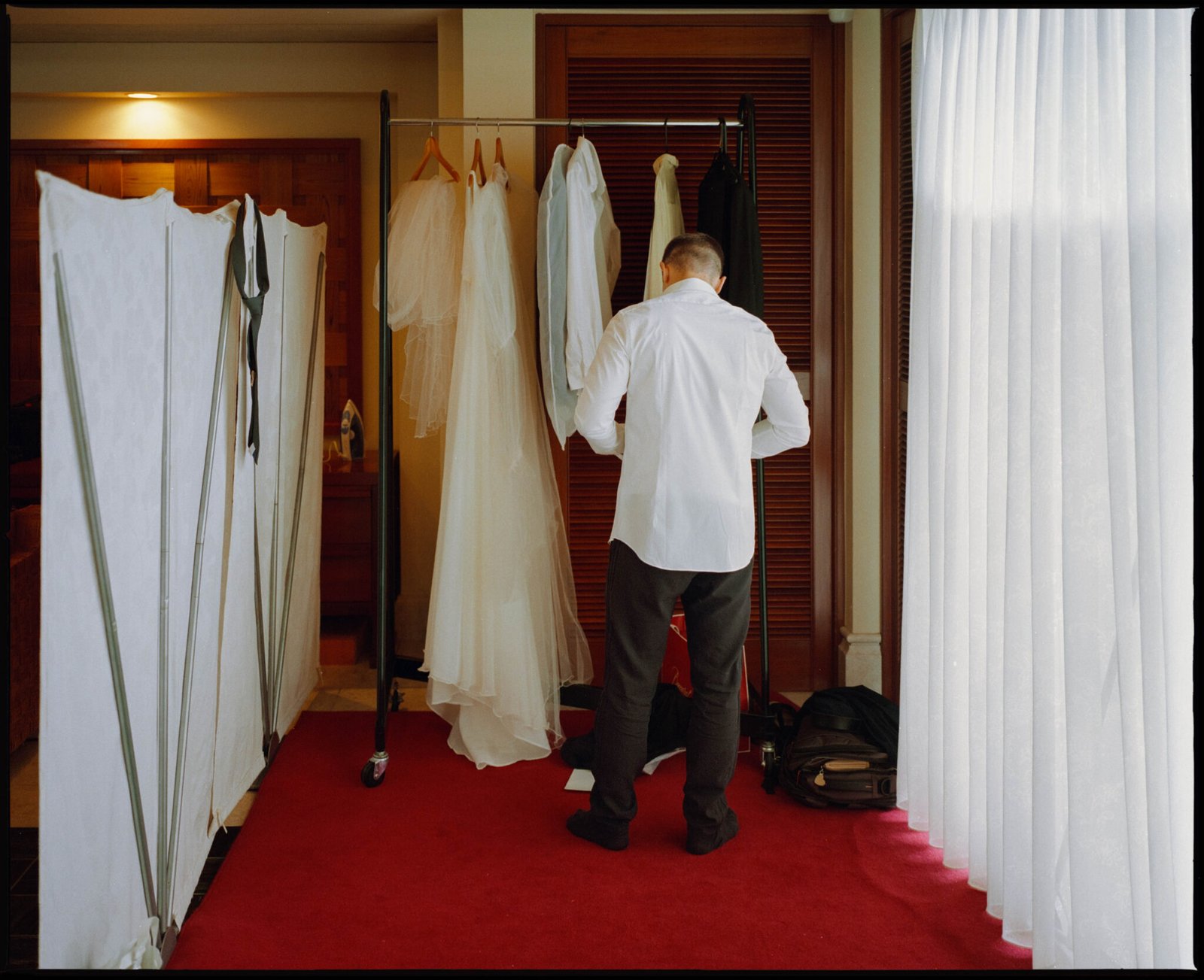The wedding dress hanging in the hallway, Sugano & Jonas wedding in Okinawa