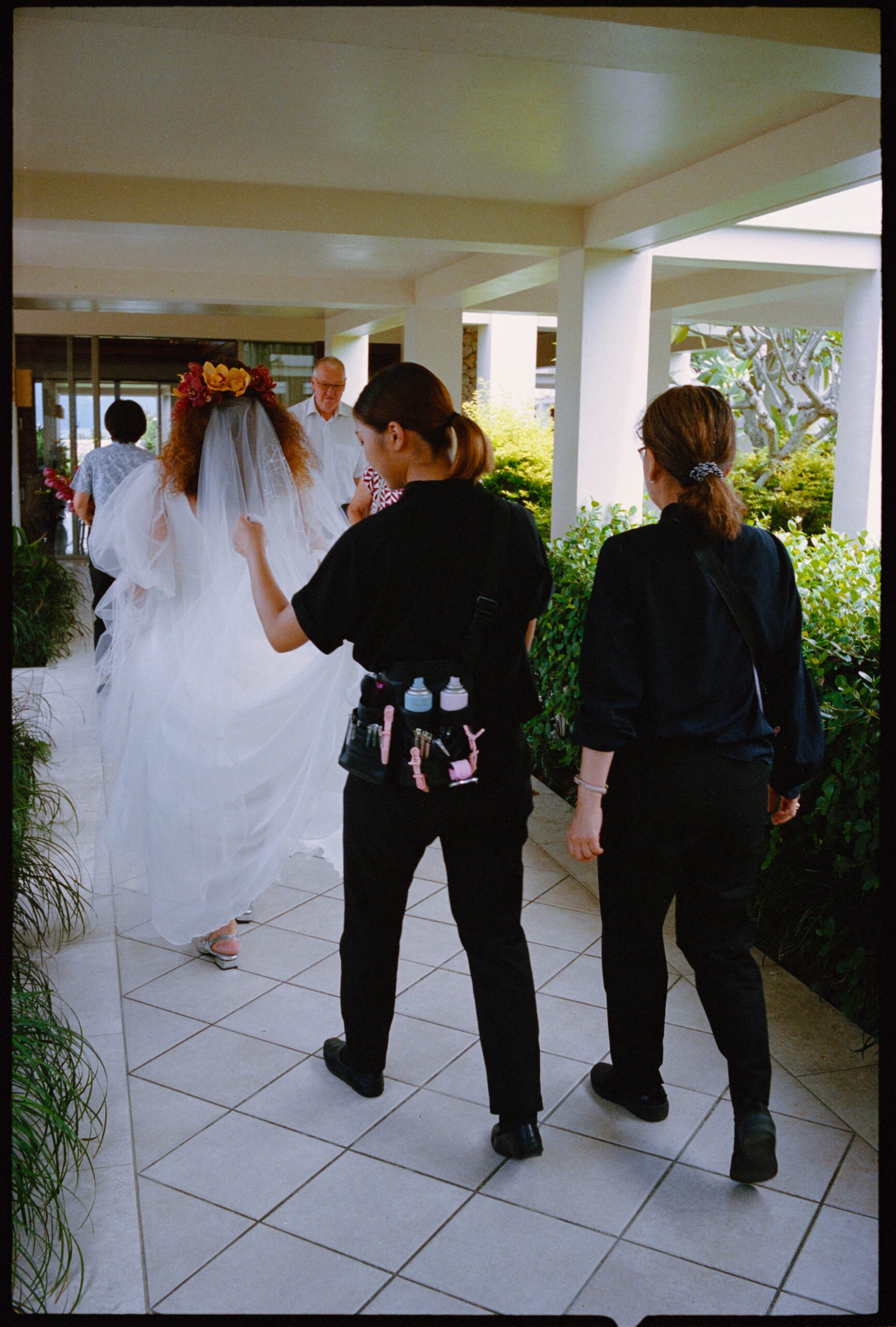 The bride walking with attendants along a walkway