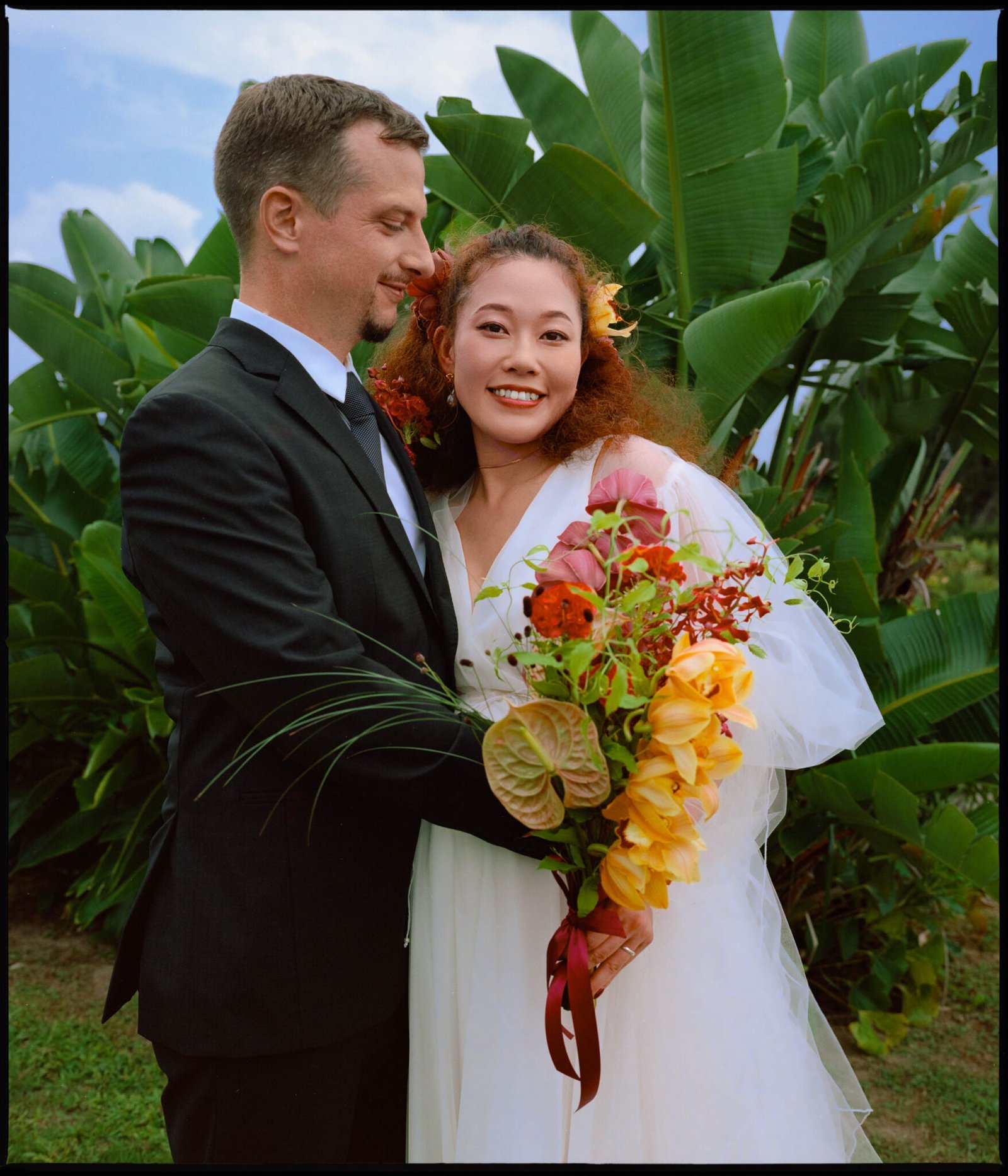 Portrait of the couple among tropical plants